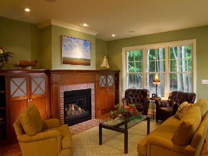 Ведущий бежевый цвет в отделке стен хорошо сочетается с мебелью красного дерева и диваном